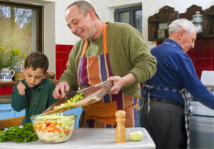 father child and grandfather cooking in the kitchen together