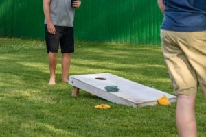 two guys playing corn hole