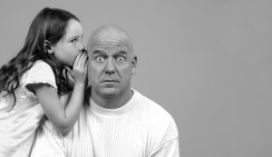 daughter whispers in fathers ear