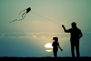 Father guiding kit with daughter