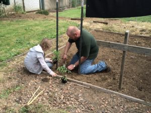 Father and daughter outside gardening