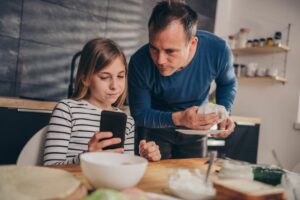 father listens to daughter who is distressed over cyber bullying